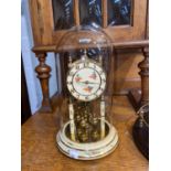 A German Kunda 400 day clock under glass dome;