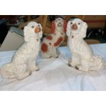 A 19th century pair of King Charles spaniels with painted faces; a similar dog