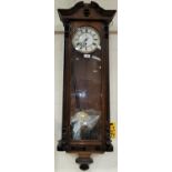 A 19th century Vienna wall clock n walnut case with ebonised finials and mouldings, single weight