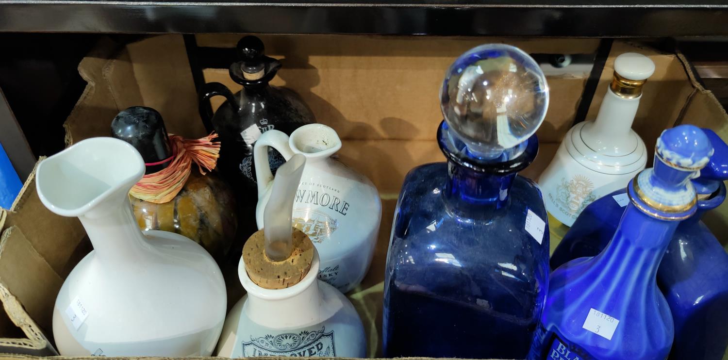 A selection of branded pottery decanters; etc.