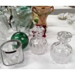 Two cut glass decanters; a similar ice pail; a glass figure of a ladies head; cranberry glass items