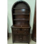 A reproduction oak dutch dresser with cupboard and drawers below