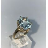 A lady's 9 carat hallmarked gold dress ring set with a large aquamarine coloured stone , size N1/