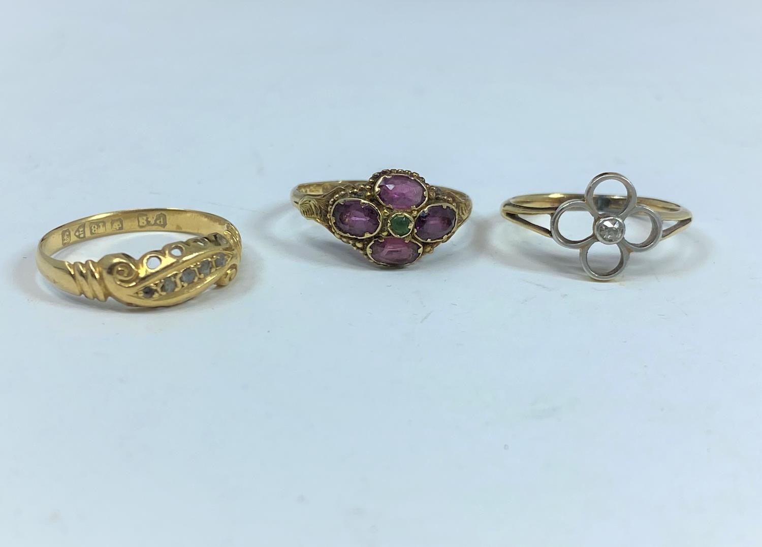 Two 18 carat gem set dress rings, 4.1gm; a 9 carat gem set dress ring, 1.3 gm