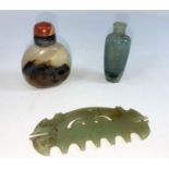 A Chinese jade coloured hard stone comb, a small jade coloured snuff bottle and another