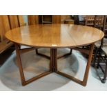 A mid century teak circular drop-leaf dining table, designed by Peter Hvidt and Orla Mølgaard-