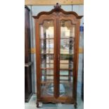 A period style stained walnut china cabinet with 2 doors