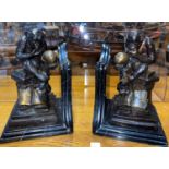 A pair of modern bronze and marble monkey and skull 'Evolution' book ends, height 23cm