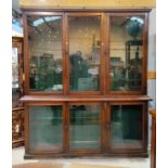 A late Victorian mahogany full height shop display case with mirror panelling to the upper