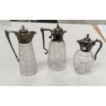 Three Victorian cut/etched claret jugs with silver rims, collars and handles