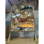 An Edwardian brass firescreen with painted mirror panel