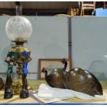 A 19th century brass oil lamp with shade and chimney; an Art Deco style pair of female figures; a