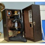 A vintage student's microscope with brass fittings, cased