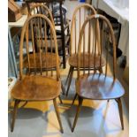 An Ercol drop end dining table on four tapering legs and four Ercol hoop back dining chairs