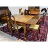 A mahogany draw leaf table and four dining chairs