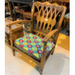 A 1930's stained wood armchair with low seat, fretwork back and needlework cushion; 2 corner linen