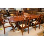 A reproduction Regency yew wood dining suite the table with rectangular extending top on twin