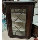 A late Georgian oak corner cupboard, single astragel glazed door enclosing three shelves, 94cm wid