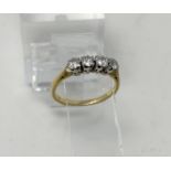 A yellow metal dress ring set 4 diamonds, stamped '18ct', 2.5 gm