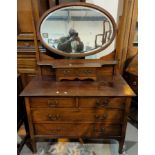 A 1920's mahogany Georgian style dressing chest with oval swing mirror, 107cm