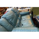 A 2 seater green leather reclining settee