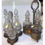 A silver plated trefoil shaped decanter stand with 3 bottles; a similar piece