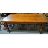 A natural pine kitchen table carried on turned legs, 187 x 92 cm, and 5 chairs