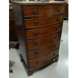 A walnut reproduction 6 height chest of drawers of narrow proportions, on bracket feet