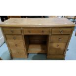 A pine kneehole desk fitted 9 drawers, 122 cm