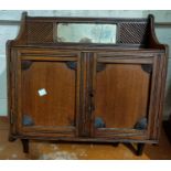 An Edwardian small bedside cabinet enclosed by carved door; a small wall cabinet