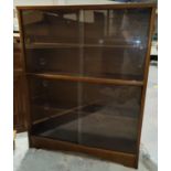 A 1960's sapele mahogany bookcase with 3 shelves and sliding glass doors, 92 cm