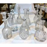 Ten various cut glass decanters