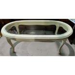 An early 20th century Italian carved coffee table with oval glass top; a similar table with