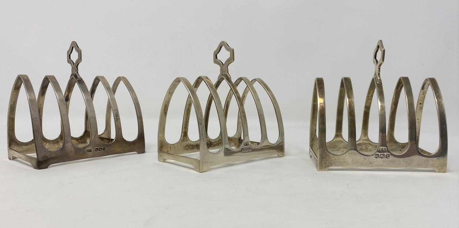 Three hallmarked silver 4 division toast racks, Birmingham 1931 - 24, length 8cm, maker E Viner, 5.