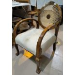 A 1930's walnut open armchair with circular caned back