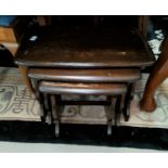 An Ercol nest of 3 tables in dark wood