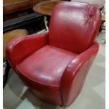 A 1930's style tub shaped armchair in red leather effect