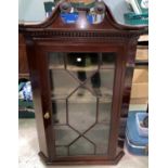 A 19th century mahogany corner cupboard with straight front, swan neck pediment and single glazed