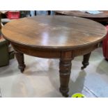 A late Victorian oak table with wind out D ends, 3 extra leaves, on heavy turned legs, length