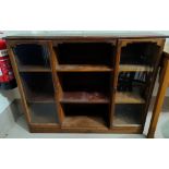 An Arts & Crafts side cabinet with 2 glazed doors and central shelves