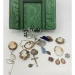 A small green jewellery box containing 5 19th century cameos and other costume jewellery