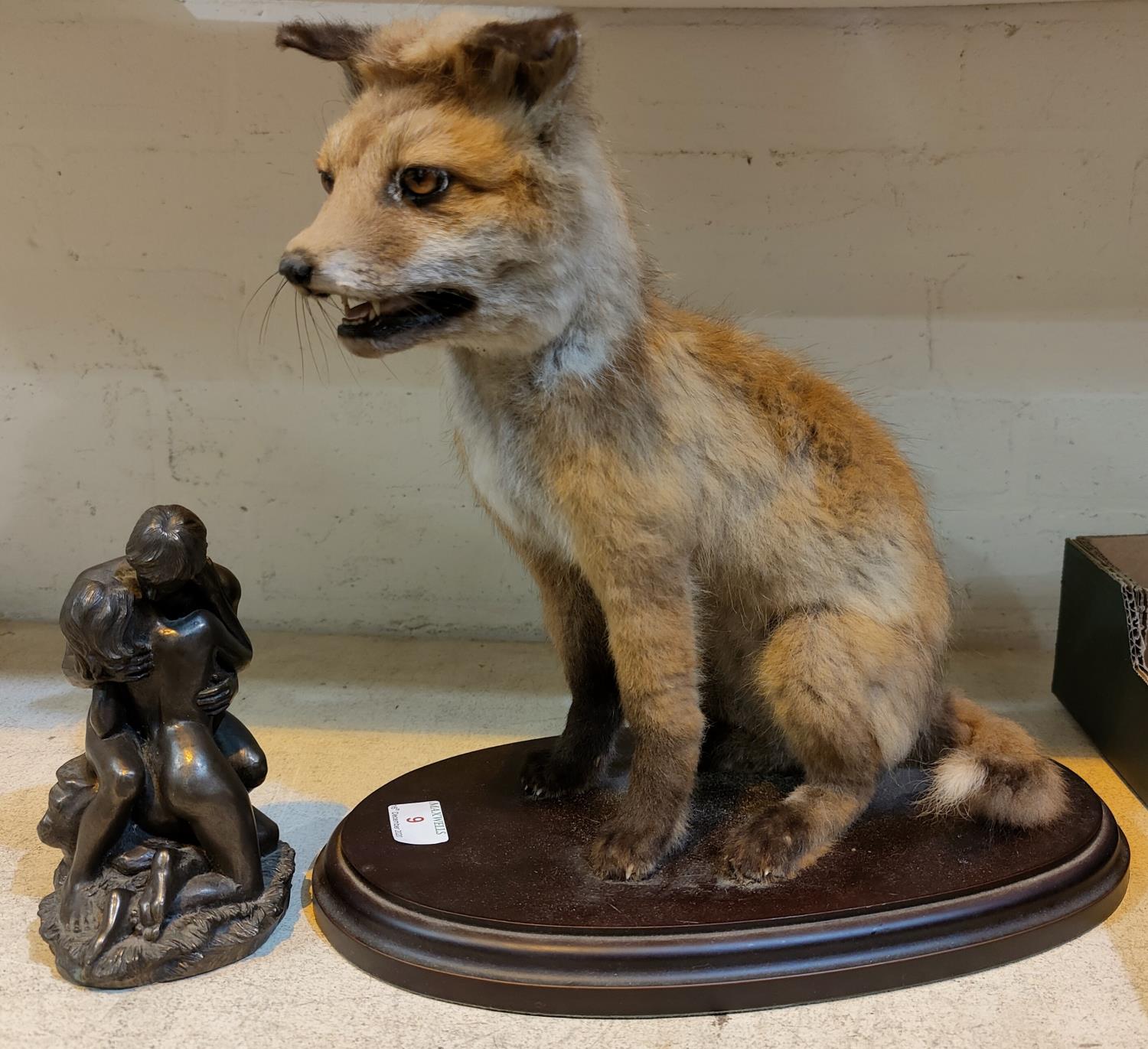 A vintage taxidermy fox cub on stand and a bronzed group Adam and Eve