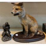 A vintage taxidermy fox cub on stand and a bronzed group Adam and Eve