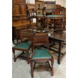 An oak set of six (4+2) dining chairs with linen fold panel backs