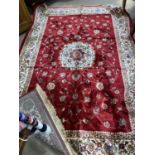 A Kashmir rug with floral medallion pattern on red ground, 240 x 160 cm