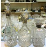 Three cut decanters with silver rims