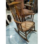 A Windsor style rocking chair with cane seat