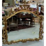 A large over mantel mirror in rococo style gilt frame