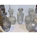 A set of 3 cut crystal decanters; 2 others