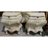 An early 20th century pair of Italian carved bedside cabinets